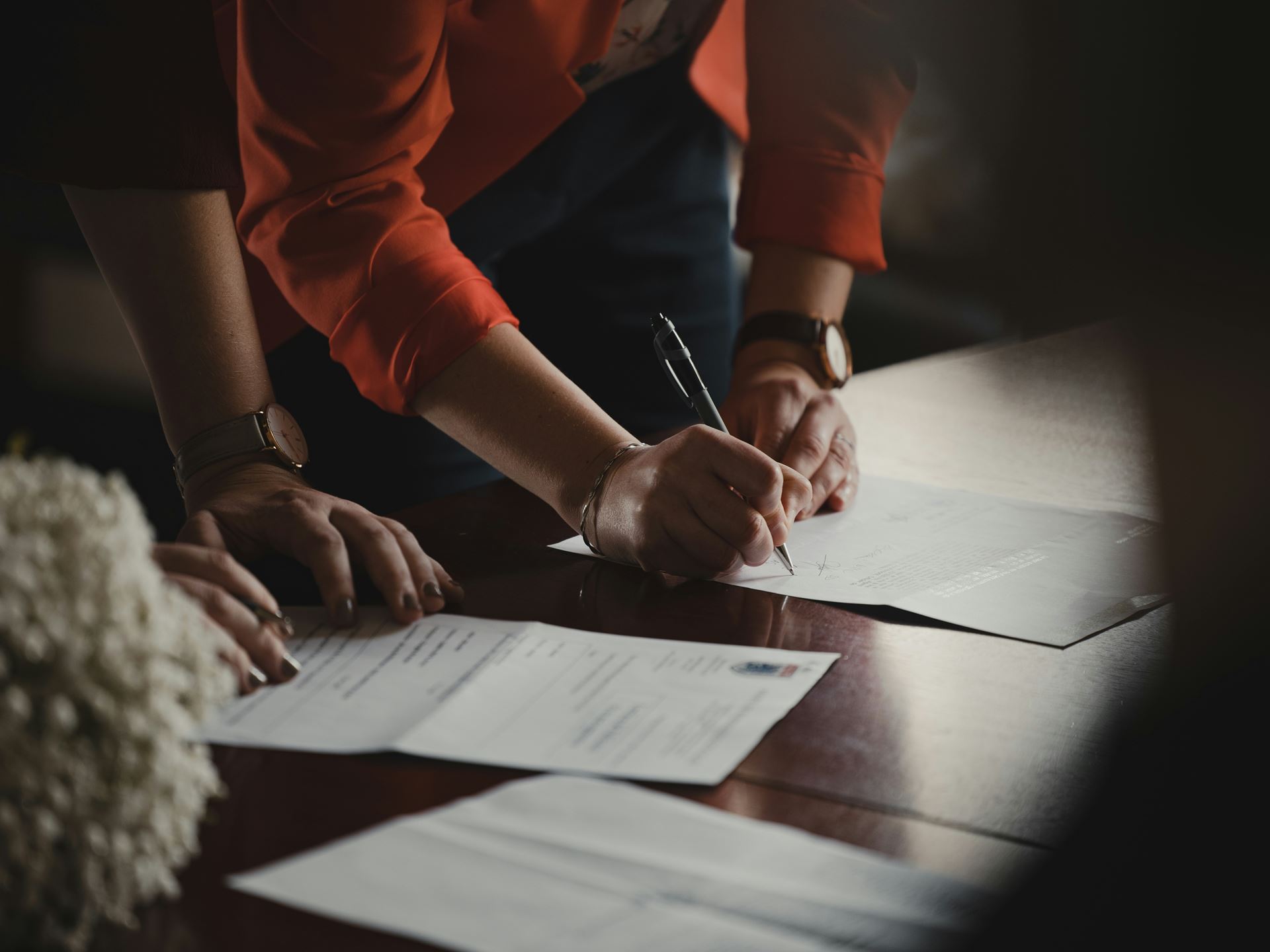 a person signing paperword